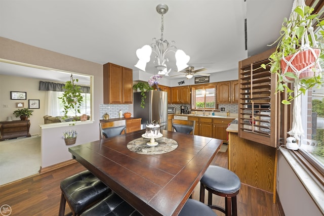 dining room featuring a ceiling fan and dark wood-style floors