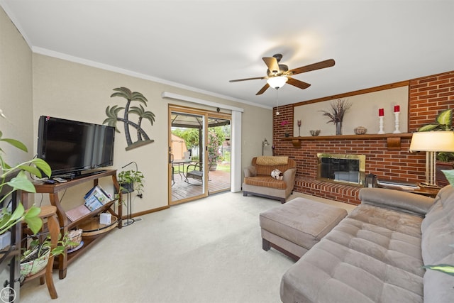 living room featuring ornamental molding, carpet floors, baseboards, a brick fireplace, and ceiling fan