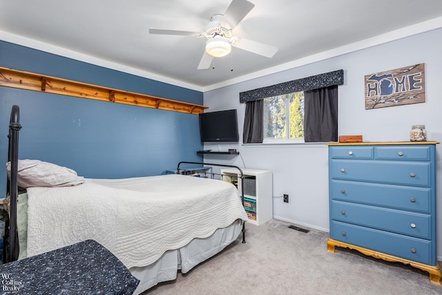 bedroom with carpet, visible vents, and ceiling fan