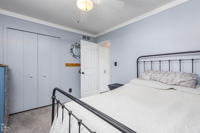 bedroom with a closet, visible vents, carpet flooring, and a ceiling fan