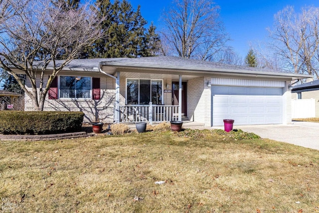 single story home featuring driveway, covered porch, a front yard, a garage, and brick siding