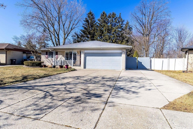 ranch-style home with a front lawn, driveway, fence, a garage, and brick siding