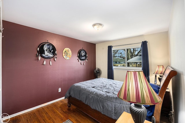 bedroom with wood finished floors and baseboards