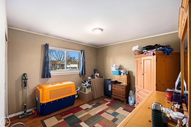 bedroom featuring wood finished floors, baseboards, and ornamental molding