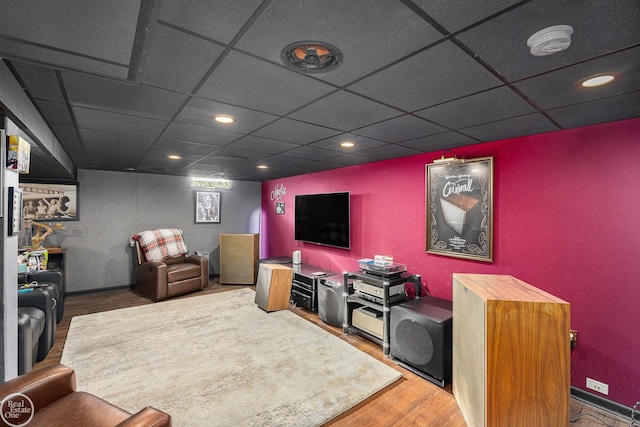 living room featuring recessed lighting, wood finished floors, and a paneled ceiling