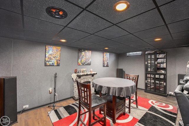 dining room featuring a paneled ceiling and wood finished floors