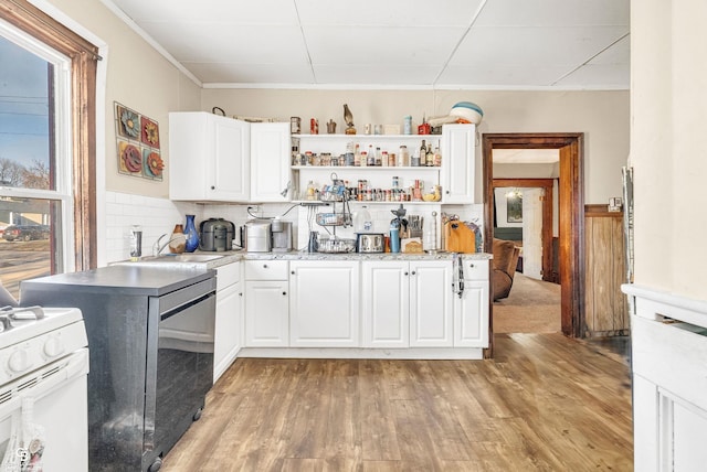 kitchen with light wood-style flooring, white cabinets, white gas range oven, and open shelves