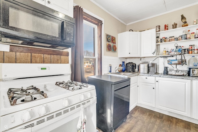 kitchen with dark wood-type flooring, crown molding, black microwave, white range with gas stovetop, and a sink