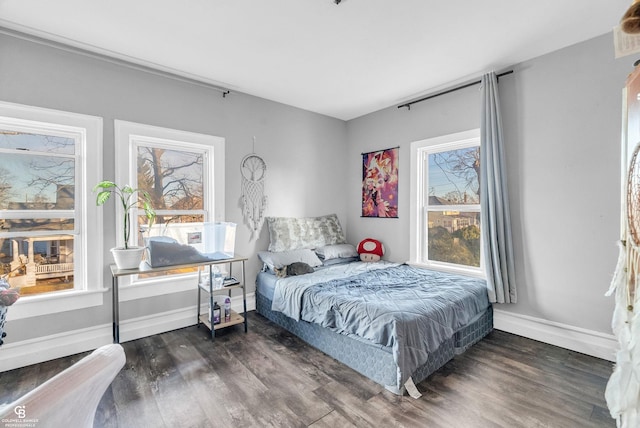 bedroom with baseboards and wood finished floors