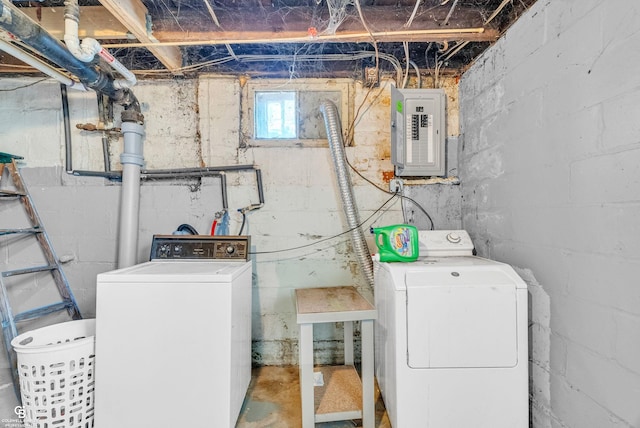 clothes washing area with electric panel, laundry area, and washer and clothes dryer