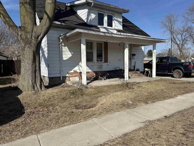 bungalow-style house with a porch and fence