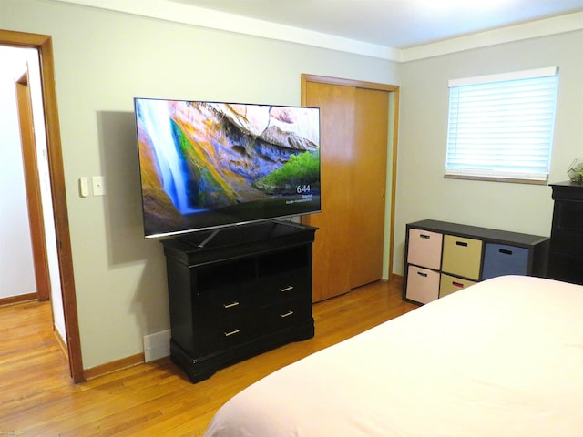 bedroom featuring baseboards and light wood-type flooring