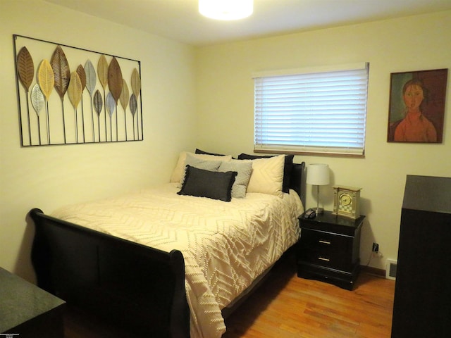 bedroom with wood finished floors