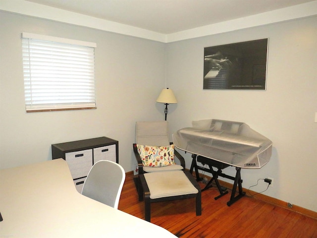 home office with baseboards and wood finished floors