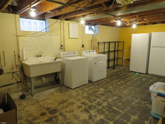 laundry room featuring washer and clothes dryer, laundry area, a sink, and dark floors