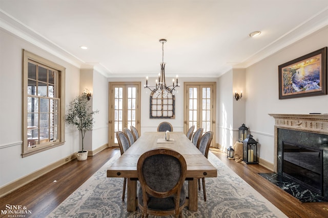 dining area featuring a wealth of natural light, french doors, dark wood finished floors, and ornamental molding