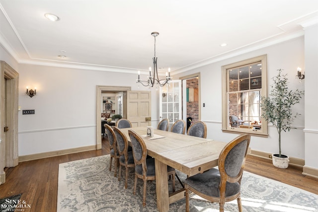 dining area featuring baseboards, a chandelier, ornamental molding, recessed lighting, and wood finished floors