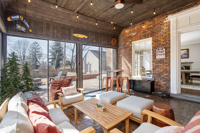 sunroom / solarium featuring lofted ceiling and ceiling fan