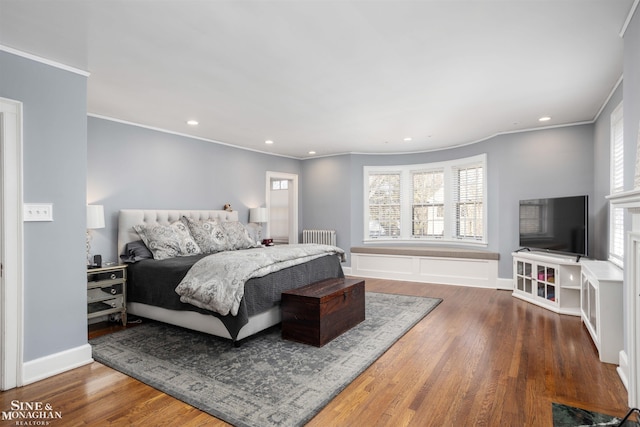 bedroom with recessed lighting, ornamental molding, and wood finished floors