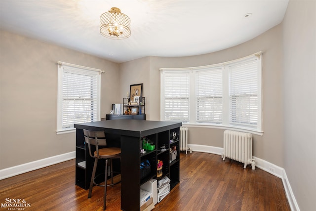 dining space with baseboards, radiator heating unit, and dark wood-type flooring