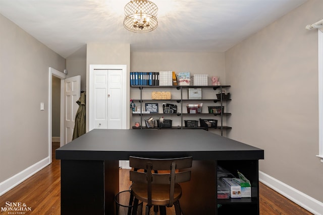 home office featuring baseboards, dark wood-style flooring, and a chandelier