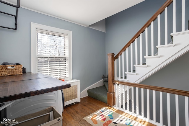 interior space with baseboards and wood finished floors