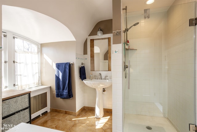 full bathroom featuring tile patterned floors, a shower stall, and radiator heating unit