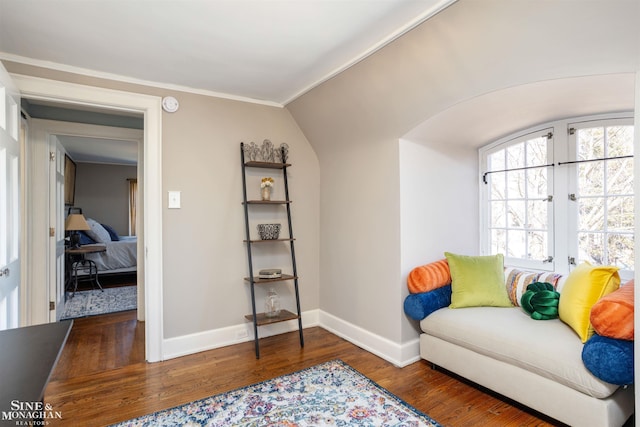 living area featuring baseboards, vaulted ceiling, french doors, wood finished floors, and arched walkways