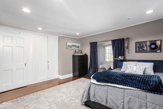 bedroom featuring recessed lighting, wood finished floors, and baseboards