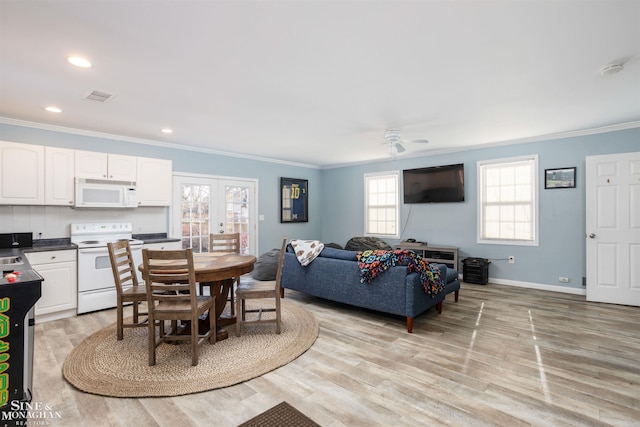 dining space with baseboards, visible vents, light wood finished floors, recessed lighting, and ornamental molding