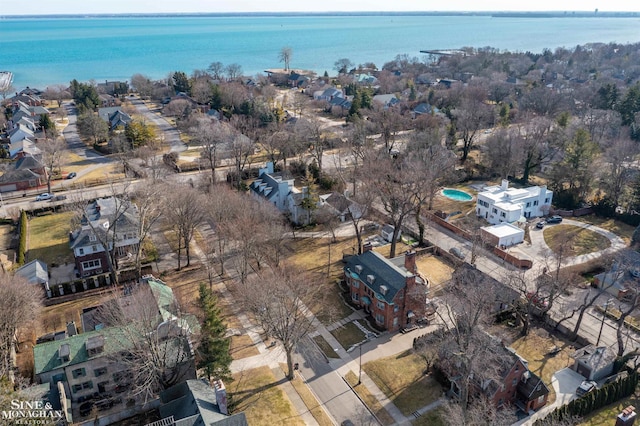 drone / aerial view featuring a residential view and a water view