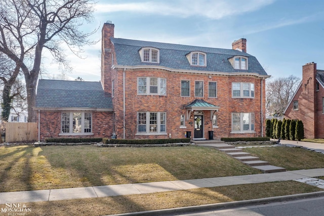 view of front of home featuring a high end roof, fence, a front yard, brick siding, and a chimney