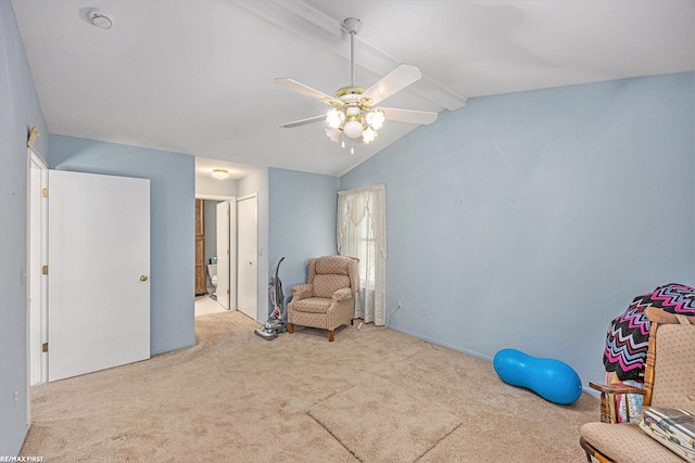 sitting room featuring lofted ceiling with beams, a ceiling fan, and carpet flooring