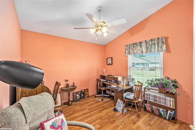 home office with lofted ceiling, wood finished floors, and a ceiling fan