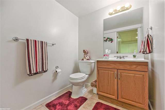 half bathroom featuring tile patterned floors, toilet, vanity, and baseboards