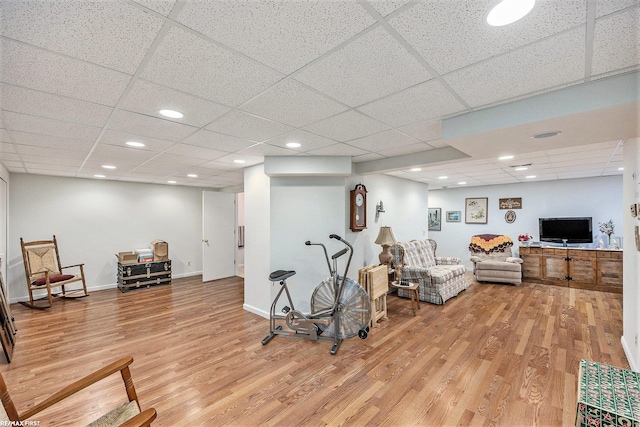 sitting room featuring light wood finished floors, recessed lighting, a paneled ceiling, and baseboards