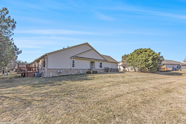 back of house featuring a yard, central air condition unit, brick siding, and a deck