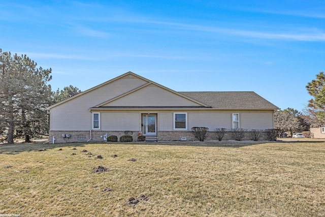 rear view of property with a yard