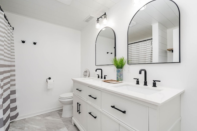 bathroom with toilet, visible vents, marble finish floor, and a sink