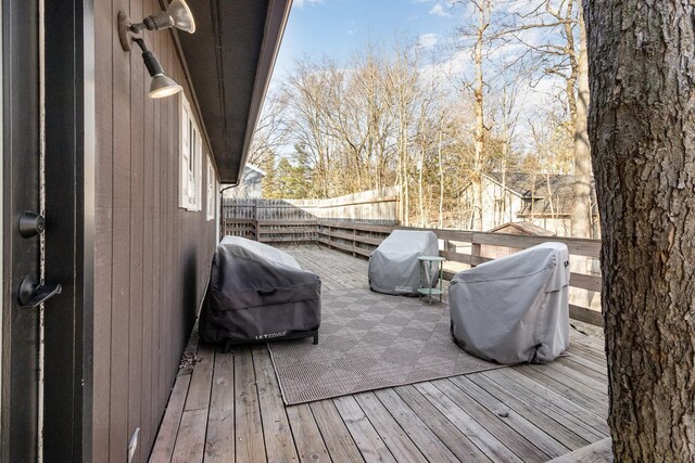 wooden deck with grilling area and fence