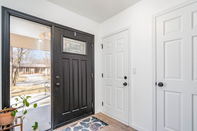 entrance foyer with baseboards and wood finished floors