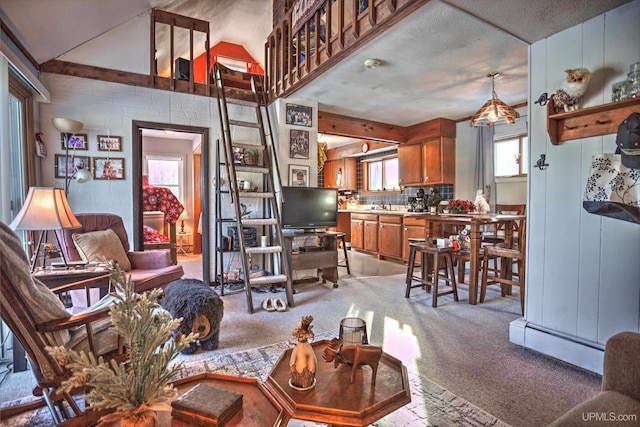 living area featuring baseboard heating and light carpet