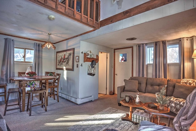 carpeted living room featuring a baseboard heating unit, a healthy amount of sunlight, and ornamental molding