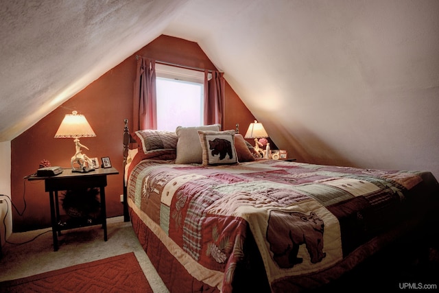 carpeted bedroom with a textured ceiling and vaulted ceiling