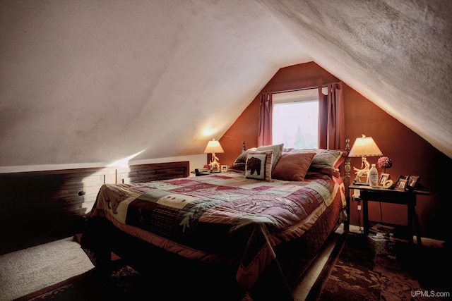 carpeted bedroom with lofted ceiling and a textured ceiling