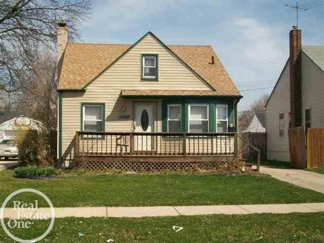 bungalow featuring fence, a chimney, a front yard, and a shingled roof