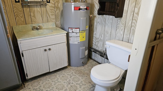 bathroom featuring water heater, toilet, and vanity