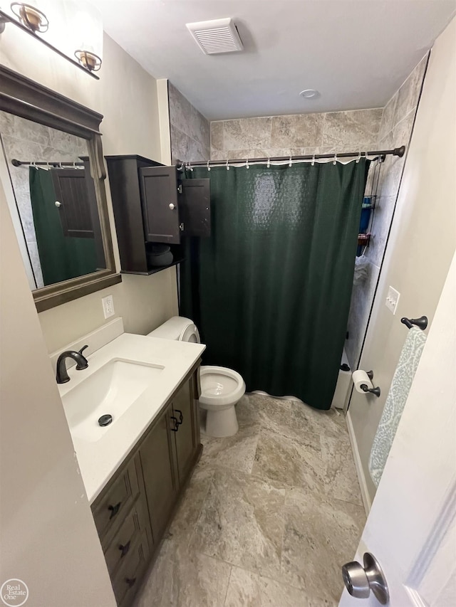 bathroom featuring visible vents, toilet, and vanity