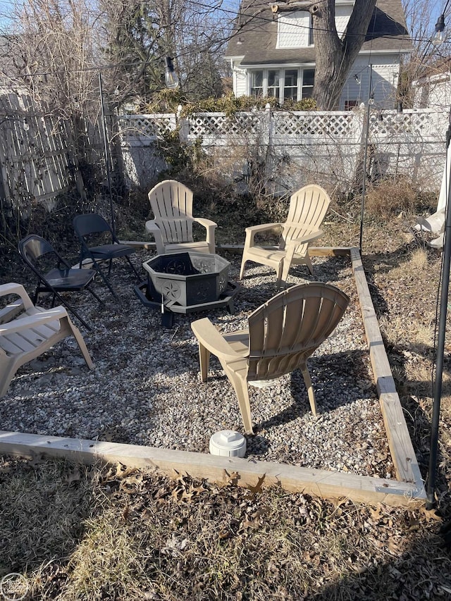 view of yard featuring a patio, fence, and an outdoor fire pit