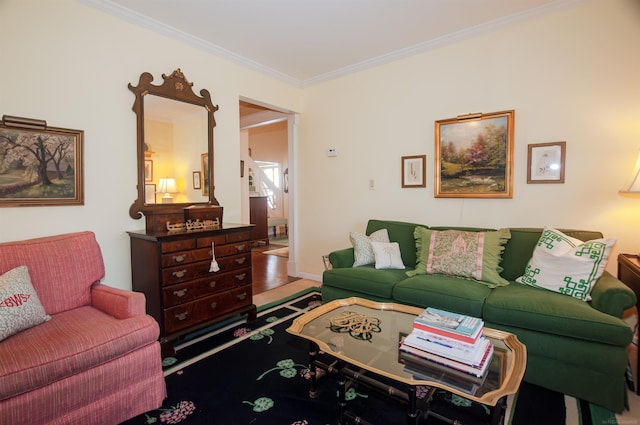 living area featuring baseboards and ornamental molding